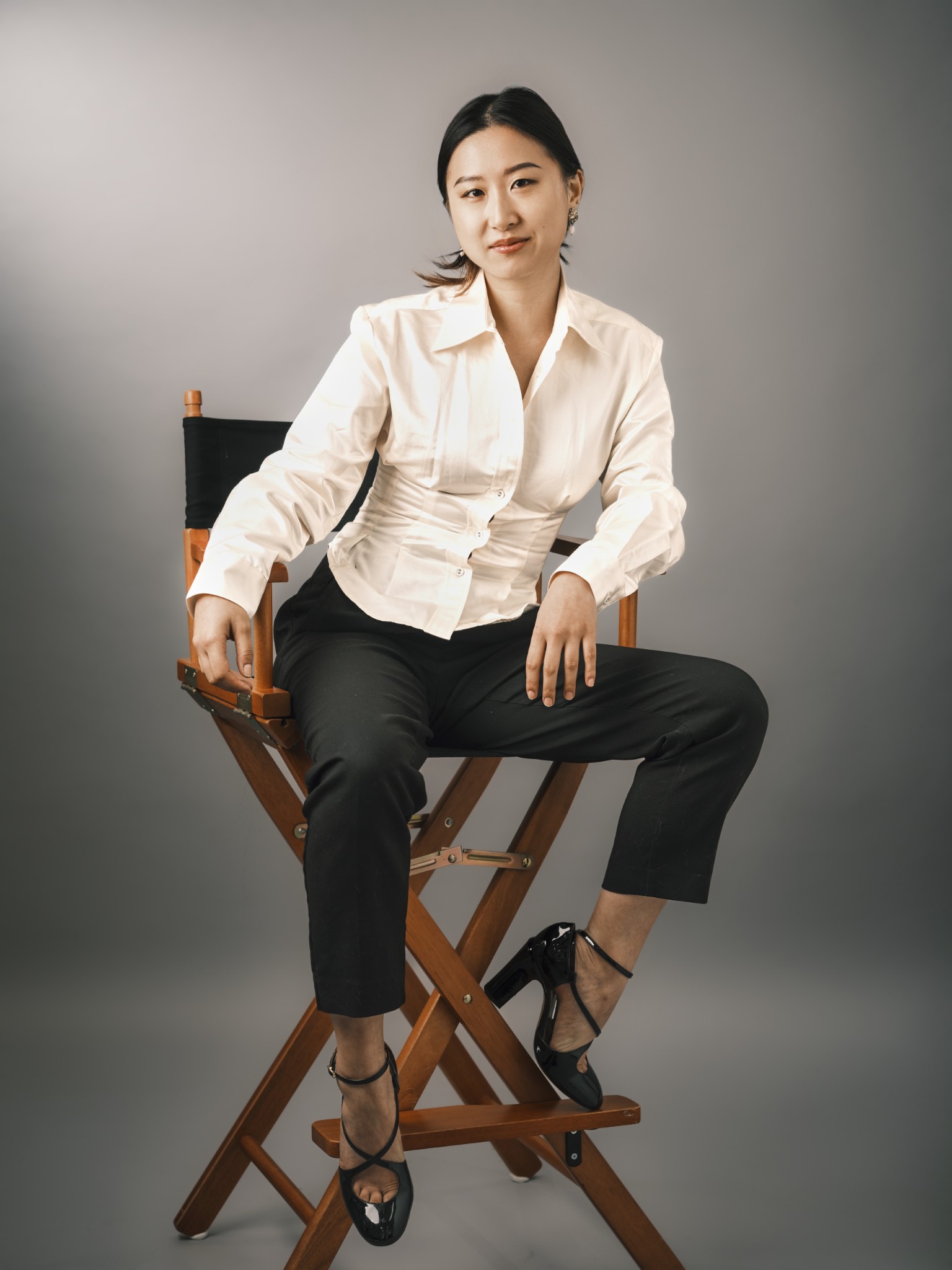 Musician seated confidently in a director's chair.